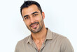 © f_bossa - A commercial portrait photo of a model on a white studio background:  a man with a beard wearing a brown shirt, smiling at the camera against a white background.