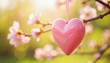 © Alina - Shiny Pink Heart Hanging on Blossoming Cherry Tree Branch in Spring Sunlight, Symbolizing Love, Romance, and Nature’s Beauty
