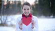 © Ozgurluk Design - Smiling Woman Holding Red Heart Winter