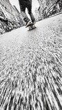 A skateboard gliding along a textured surface, captured in a dynamic perspective.