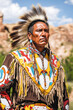 © romanets_v - Native american man in traditional regalia with feathered headdress outdoors