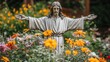 © Hryhor Denys - A serene garden showcases a statue of Jesus Christ with arms outstretched, surrounded by vibrant flowers in various colors, creating a peaceful atmosphere
