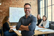 © Myimages - Our business is built on confidence. Cropped shot of a businessman standing in the office with his arms folded looking confident and smiling at the camera