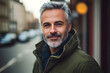 © Prasanth - Portrait of a handsome middle-aged man with gray hair and beard in a green jacket in the city