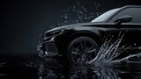 A black car is driving through a puddle of water. The water is splashing up around the car, creating a sense of motion and energy. The image conveys a feeling of excitement and adventure