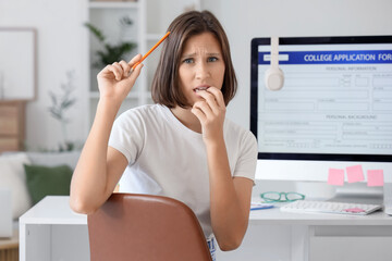 Wall Mural - Worried teenage girl thinking about college application at home