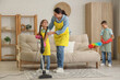 © Pixel-Shot - Cute little children helping their mother with cleaning routine at home