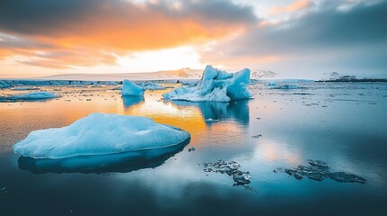 Wall Mural - Glacial lake sunset with icebergs reflecting in calm water.