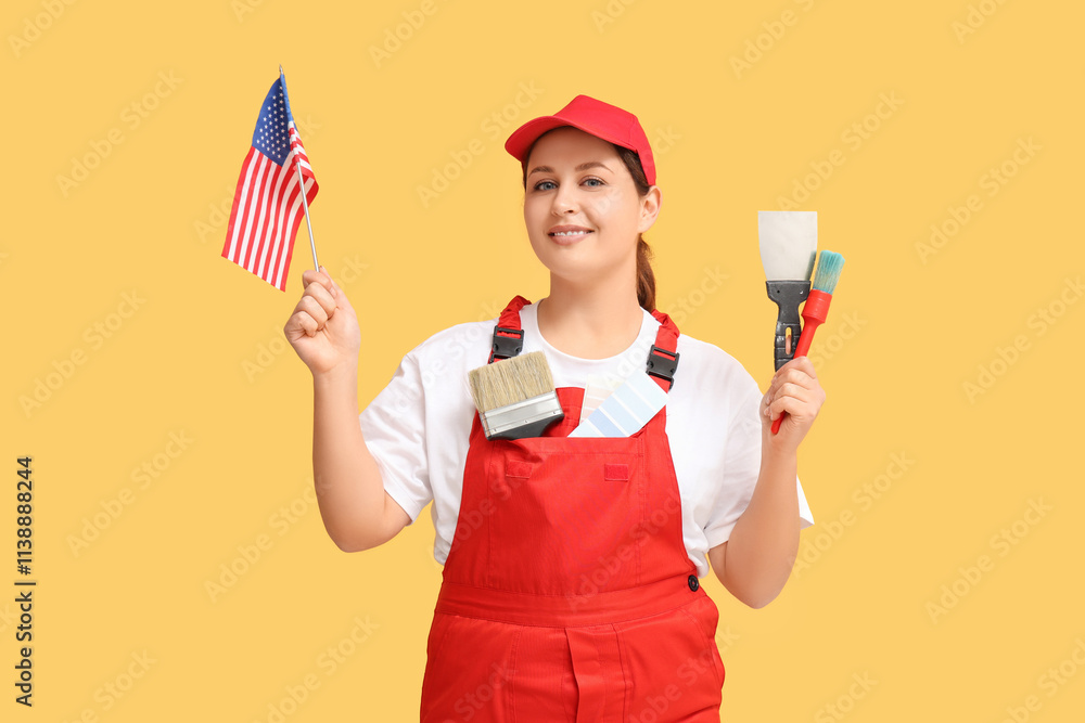 Young female painter with USA flag and brush on orange background