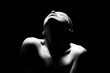 © Pixel-Shot - Silhouette of young woman on dark background, closeup