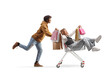 © Ljupco Smokovski - African american man pushing an asian woman with shopping bags inside a shopping cart
