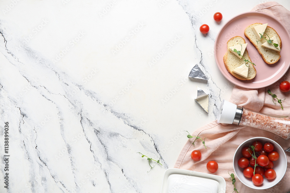 Composition with fresh bread, triangles of tasty processed cheese, sea salt and tomatoes on light background