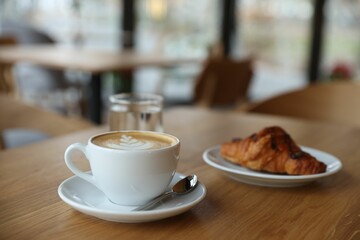 Delicious breakfast served on wooden table in cafe, closeup