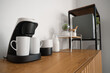 © Pixel-Shot - Coffee machine with cups on commode in office, closeup