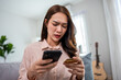© Kawee - Asian frustrated woman making online payment failure on phone at home.