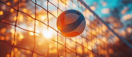 Wall Mural - Volleyball in net at sunset.