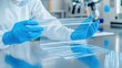 © watcharee - A lab technician in protective gear interacts with transparent lab materials, emphasizing precision and safety in a scientific environment.