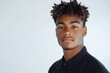 © J. Grayscale - Confident Young Man with Stylish Hair and Black Shirt Posing Against a Light Background