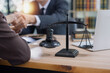 © SOMKID - Lawyer man shaking hands with customer, Contract agreement, Lawyer or judge consult.