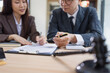 © SOMKID - Lawyer or judge consult, Businessman and woman lawyers discussing about contract and agreement concept.