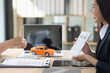 © SOMKID - Car contract agreement concept. Asian car saleswoman and  customer.