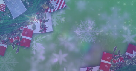 Wall Mural - Image of falling snow and christmas gifts over green background