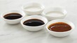 © Pannee - Assorted Sauces in White Bowls on Marble Surface
