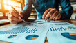 © remake - Businessman analyzing investment charts. Accounting and finance concept. Financial data analysis and strategy planning. Professional working growth report. Business management and budget development.