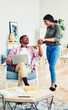 © BullRun - Carefree woman supporting successful husband doing remote work with startup project, cheerful dark skinned wife assist skilled man about freelance job in home apartment with cozy loft interior