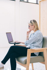 Wall Mural - caucasian woman using laptop for web messaging with blog followers connecting to 4g wireless interne