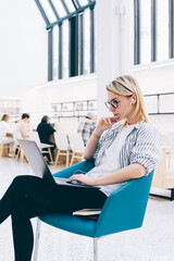 Wall Mural - millennial freelancer in electronic earphones watching online tutorial webinar for improve programmi