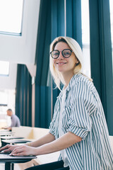 Wall Mural - portrait of happy skilled woman in glasses connecting to 4g wireless on laptop technology and posing
