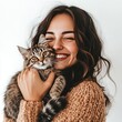 © ANILCHANDRO - A woman holding a cat and smiling isolated on a white background