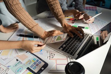 Wall Mural - creative ux ui design process with team collaborating on mobile app interface prototypes and wirefra