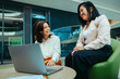 © Jacob Lund - Female colleagues discussing growth and finance strategies in a modern corporate office setting