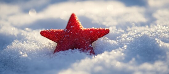 Wall Mural - Red star ornament resting on a snowy backdrop capturing the essence of winter and holiday decoration in a serene natural setting