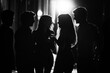 © Michael - Black Silhouette of a group of friends chatting and laughing on a street corner at night on a white background.
