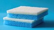 © Kultivad - Dishwashing sponge duo on vibrant blue background perfect for cleaning product promotions and kitchenware advertisements