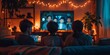 © Jane_S - Children gathered on a cozy couch, watching a movie with a screen glowing in a dark, warmly lit room.