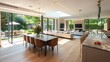 © Ali - Open-plan living and dining space with light oak flooring, beige furniture, a marble dining table, and floor-to-ceiling glass windows overlooking a garden. interior design concept