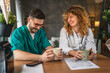 © Miljan Živković - two doctors colleagues man and woman enjoy on break with coffee at home