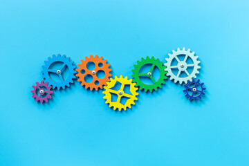 Colorful gears are connected together as a symbol of teamwork and business automation