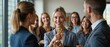 © NoblePix - Business success concept. Happy winning businesswoman receiving business award and holding trophy with group of happy workers. Celebrate and congratulate your leaders for their great successes at work