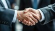 © Oktyabrskiii - Business professionals engaging in a handshake to signify agreement in a corporate setting