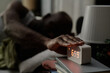 © AnnaStills - Unrecognizable male hand on alarm clock, he trying to stop in morning time