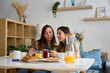 © ADDICTIVE STOCK - Lesbian couple enjoys breakfast at home together