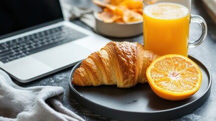 Fresh Breakfast Tray with Croissant and Orange Juice Beside Laptop for Morning Inspiration and Productivity, Business Breakfast