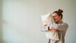 © ChrisKuz - Woman hugging soft pillow with happiness