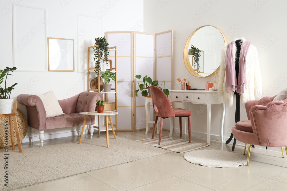 Stylish interior of light room with dressing table and houseplants