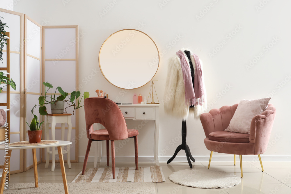 Stylish interior of light room with dressing table and houseplants